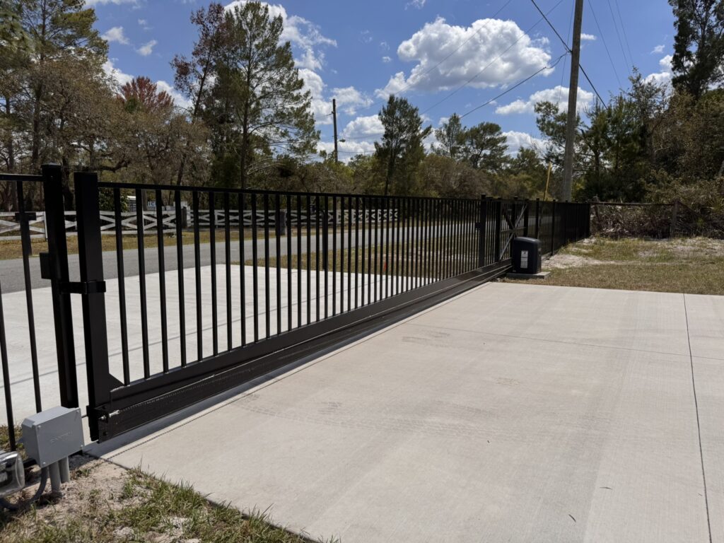 Automatic sliding gate with gate operator installed in Orlando commercial property